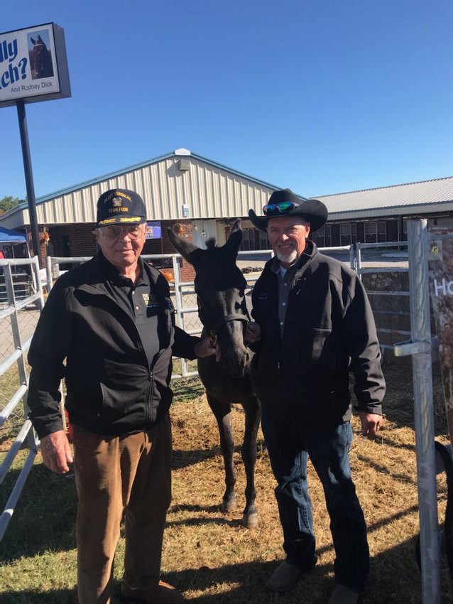 Capt. Robert Arnold, left, visited with Marty Gordon  at the American Mules and Bluegrass Festival, which  was held recently at the Calsonic Arena.