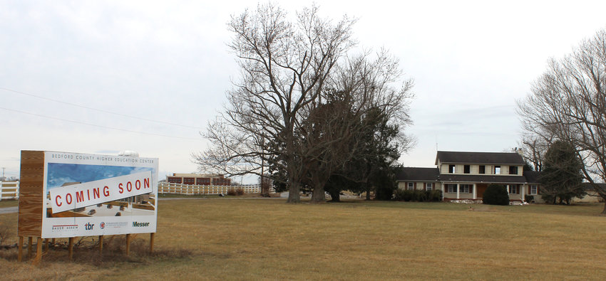The past and future of the U.S. 231 North corridor is clearly visible in the area across from Shelbyville Municipal Airport. A sign proclaims the upcoming new Tennessee College of Applied Technology-Shelbyville campus, one of several replacement campuses proposed across Tennessee. Russell Plaza, background, is one of several medical-related buildings near Vanderbilt Bedford Hospital. The house at right is being demolished or moved as a once-residential area is reoriented toward industries and businesses.