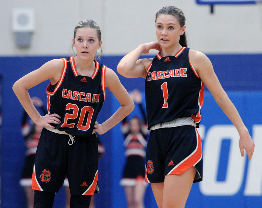 Cascade&rsquo;s Anna Clanton (20) and Laina Carter catch their breath during some free throws in the second half.