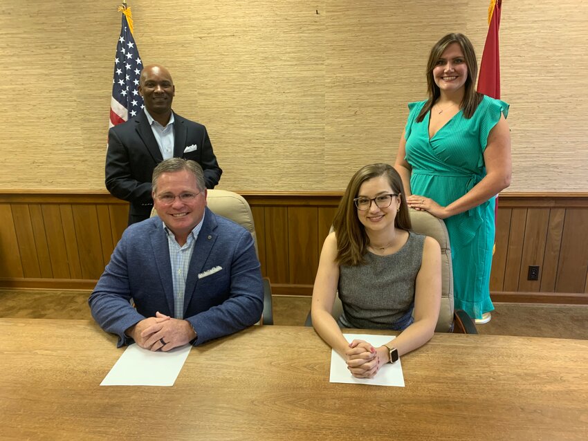 The Shelbyville-Bedford Partnership and the Shelbyville-Bedford County Chamber of Commerce have merged. Signing the merger papers are, seated, Partnership chair David Coffey and Chamber chair Elisabeth Thompson. Standing, left, is Partnership CEO-President Shane Hooper and Yolanda Flick, Chamber CEO.