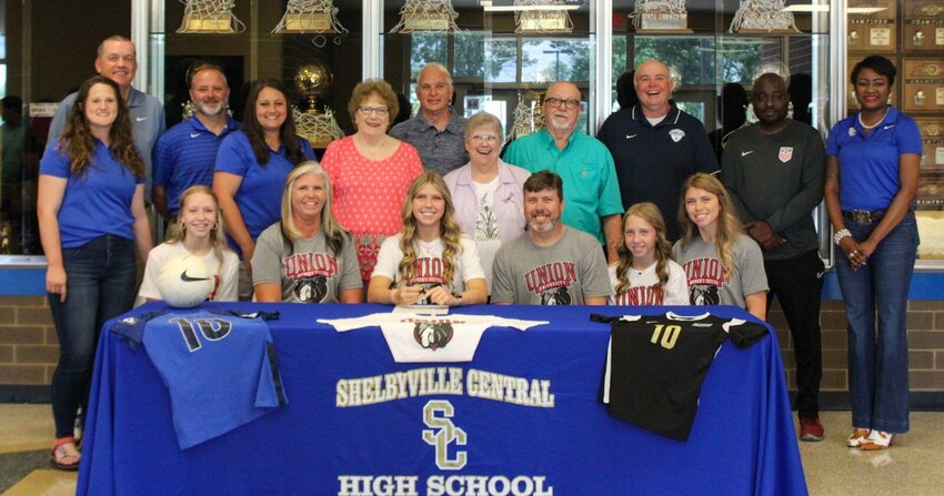Paige Blackburn (center) signed with Union University on Friday to continue her soccer career.