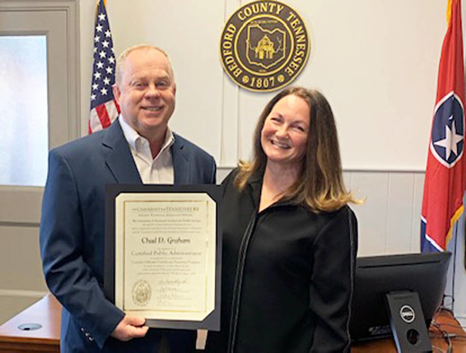Mayor Chad Graham is congratulated by Melisa Kelton of the University of Tennessee Institute for Public Service on achieving the status of Certified Public Administrator.