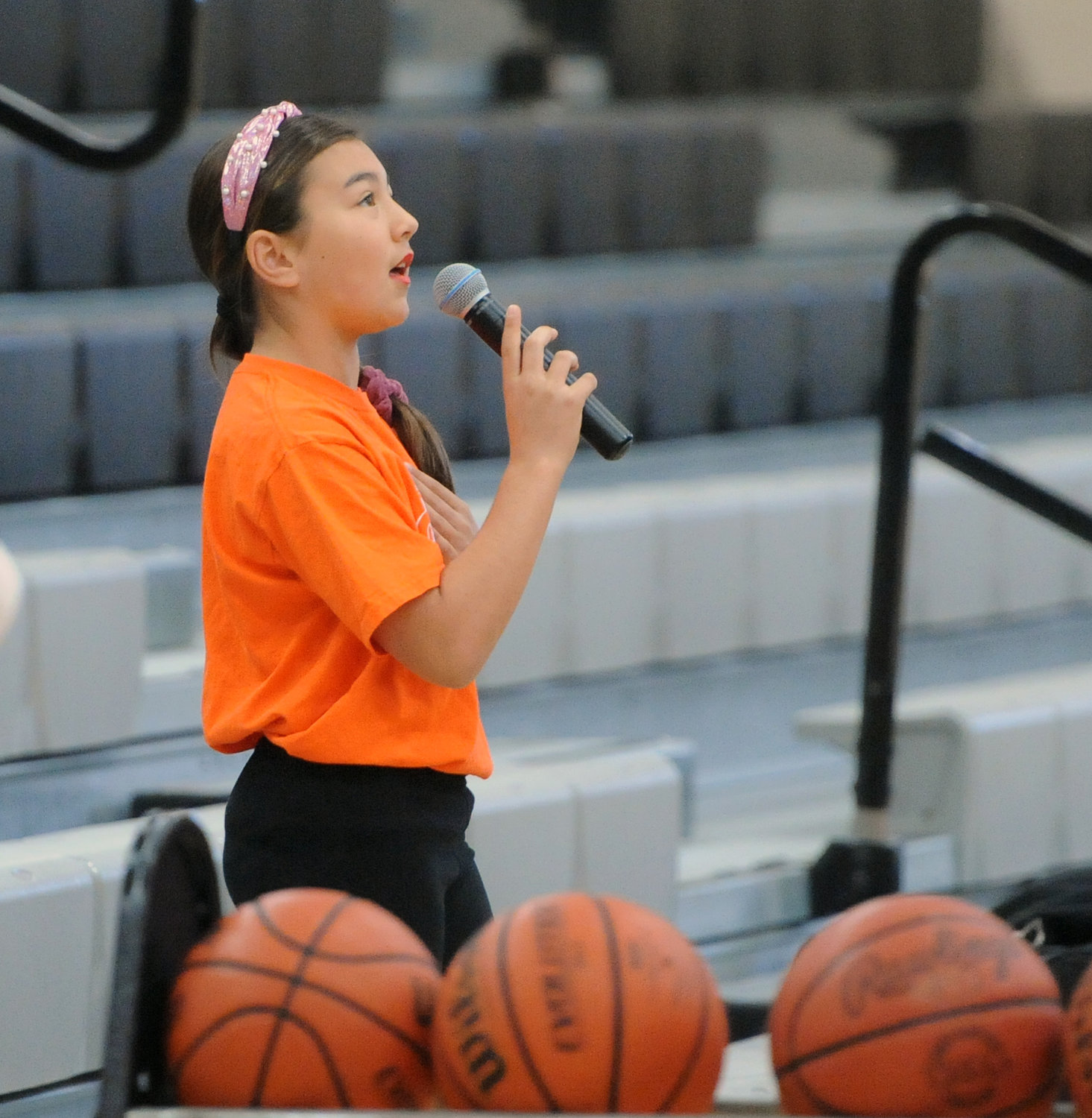 Grace Shibiyama sings the national anthem before the first game tipped off on Saturday.