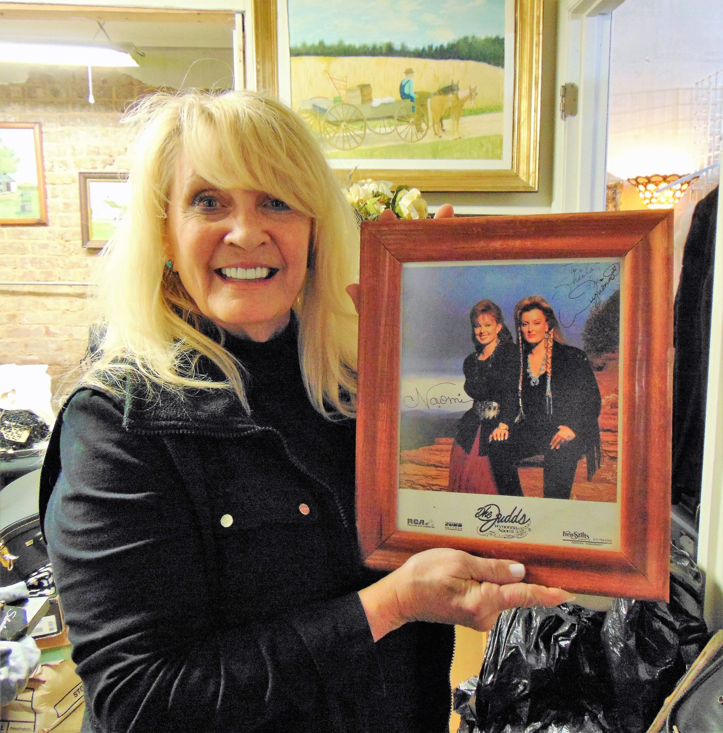 Sheila LeDere holds a picture of the country group, The Judds, at a set in Arizona where
she helped to create their wardrobe.