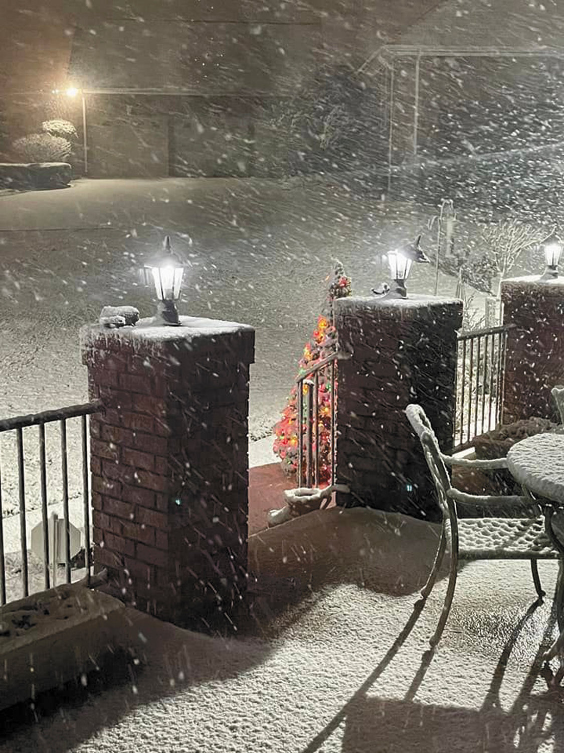 Snow flies around the patio during Sunday night’s snowstorm.
