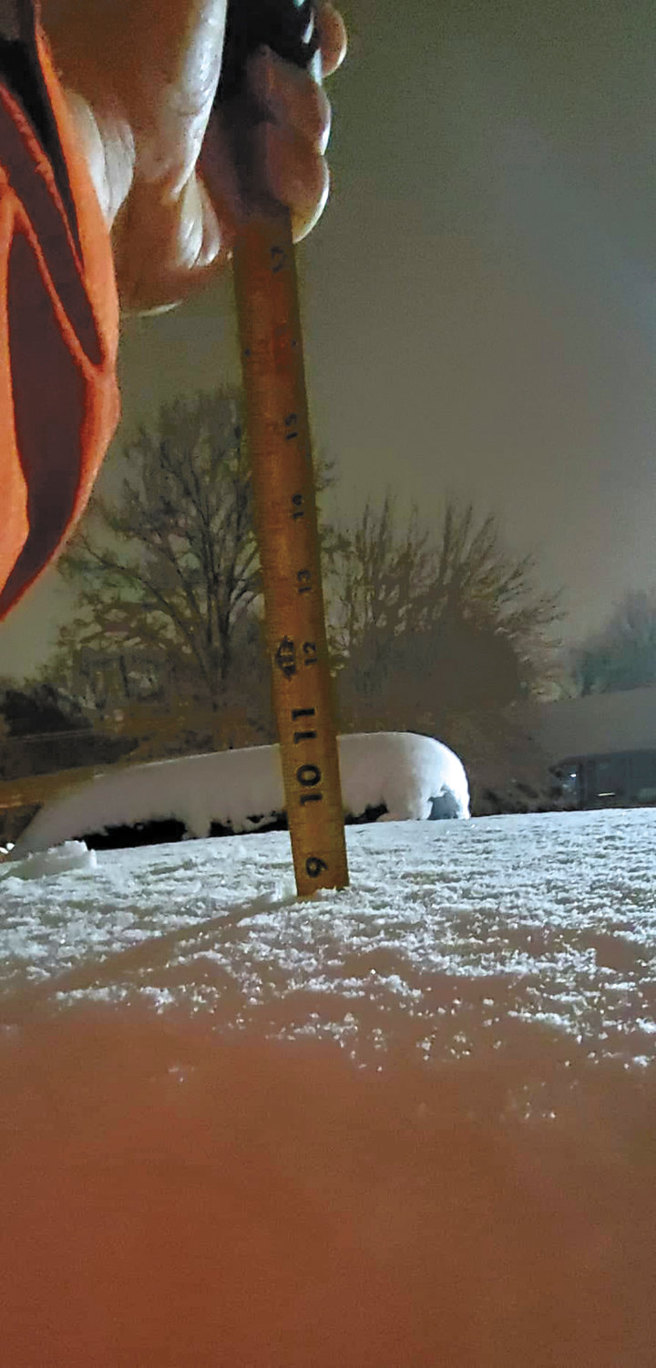 The yardstick tells the story: 9 inches of snowfall.