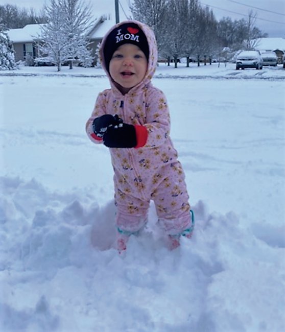 Mia Ramirez, 1 1/2-year-old daughter of Taylor and
Diego Ramirez, enjoyed her first venture into the white
stuff this week.