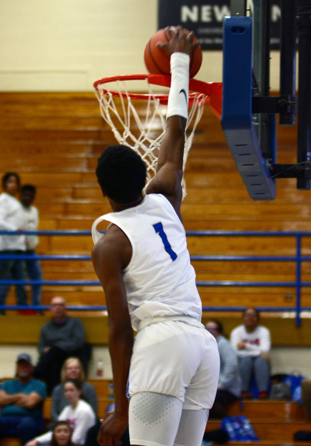 Shelbyville Central senior Jayshon Jones leaps high with his arm above the rim to cap off an impressive slam dunk in the Eagles win over district for Warren County on Tuesday night.