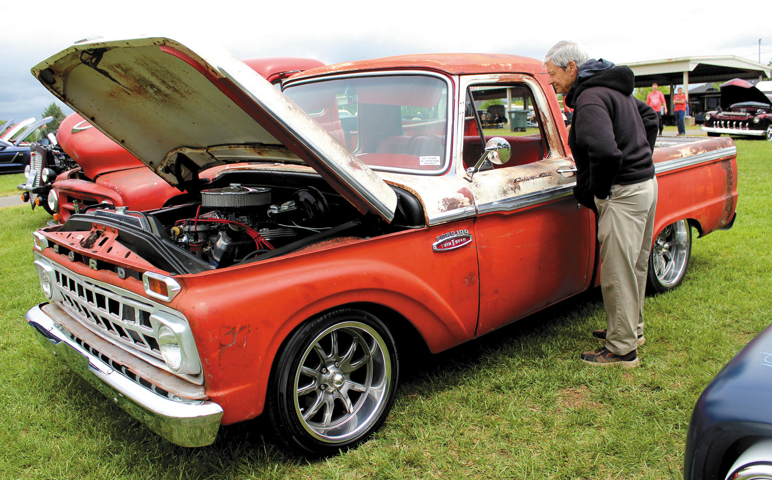 Morris Helton looks over a mid-1960sFord pickup. Helton was displaying a 1980sOldsmobile and also owns a 1957 Ford Fairlane