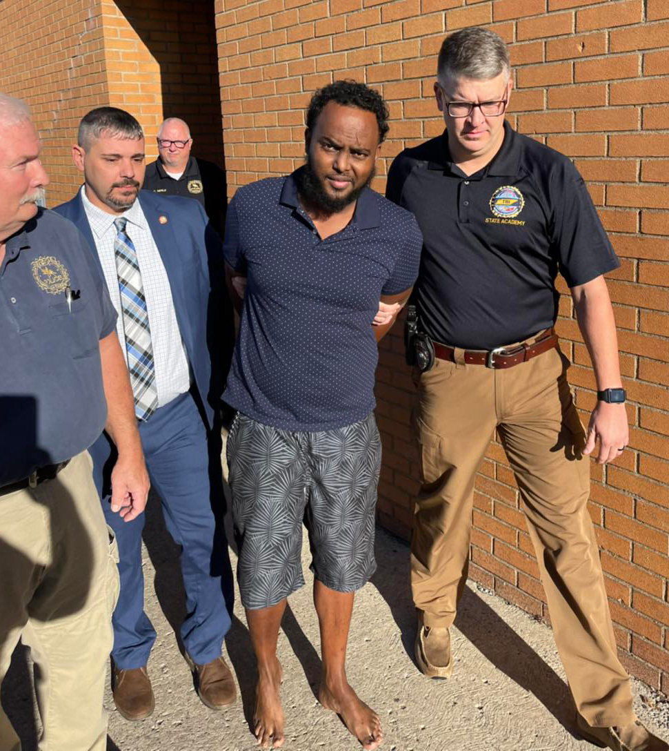 Mohamed Miray is returned to Shelbyville following his arrest Tuesday. From left are Detective Sgt. Sam Jacobs, Detective Nathaniel Everhart. Detective Lt. Charles Merlo (at rear) and Detective Cody Swift of the Shelbyville Police Department.