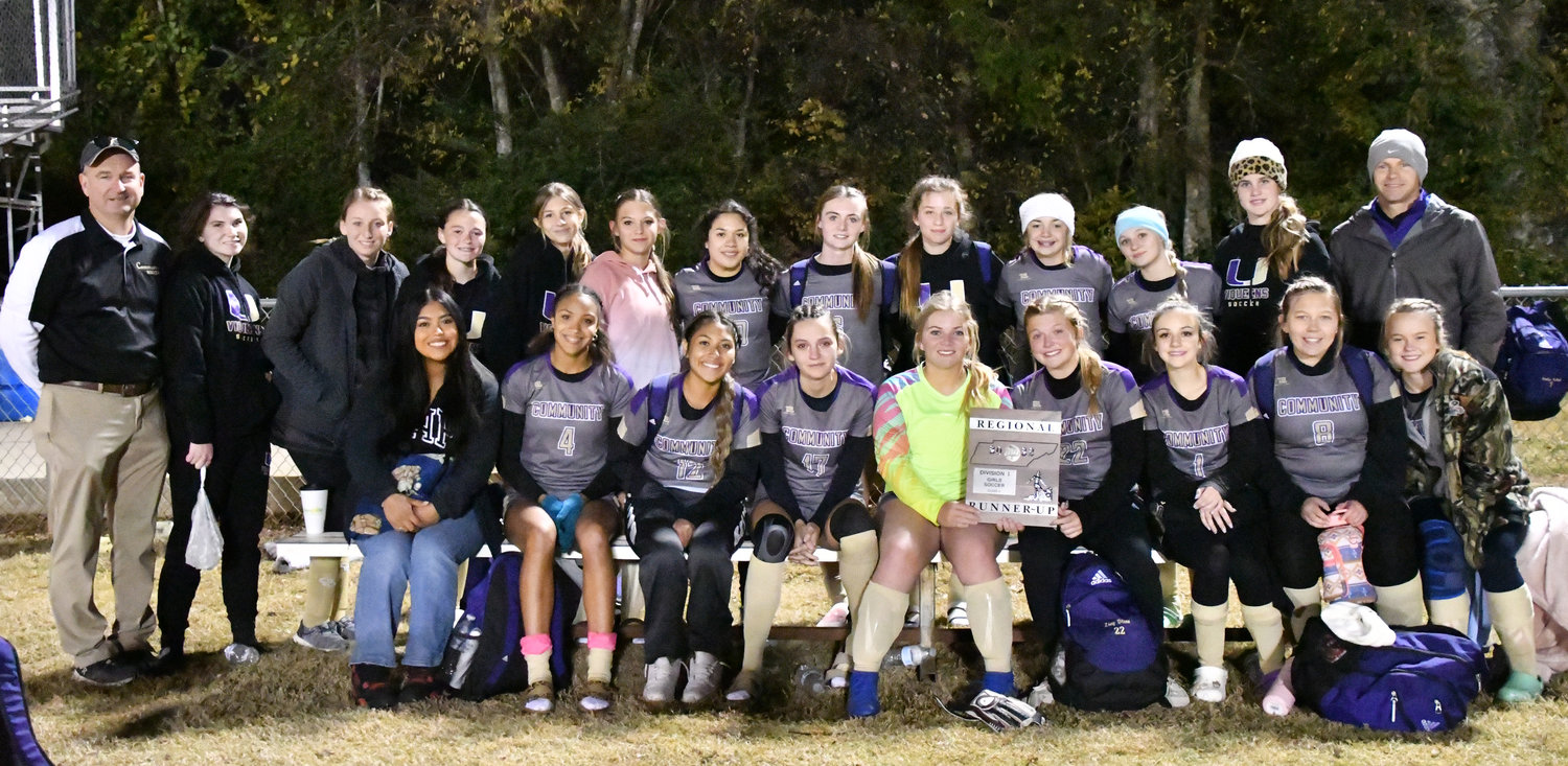 The Community Viqueens pose with their runner-up hardware in the Region 3A soccer tournament final.