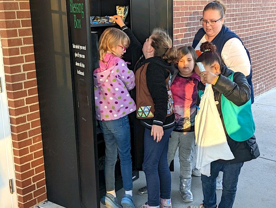 Girl Scout Troop 2794 delivered non perishable foods to 16 local Blessing Boxes on Monday. Troop members making the deliveries were: Essence Hickmon, Ellie Mantooth, Alice Keown  and Olivia Gossar. Troop leader Barbara Gossar is shown with them at the Edgemont Baptist box. Parents Sabrina Keown and Jay Mantooth are not pictured.