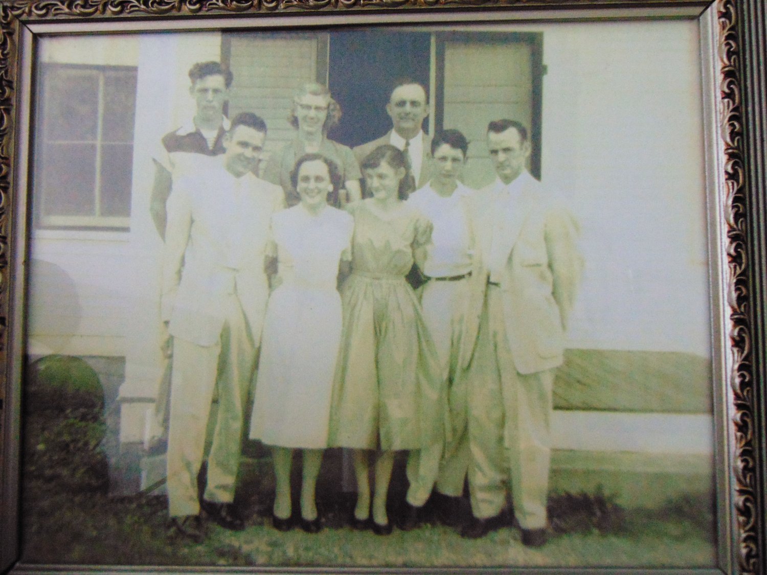 An old photo of
the Fann family from the
early 1950s. Morris and
Dorris are on the end of
the first row, respectively.
Wilma and Bill are third
and fourth in the front row,
respectively. Also pictured
are their parents, in the
back row, and a brother
and sister (not twins).