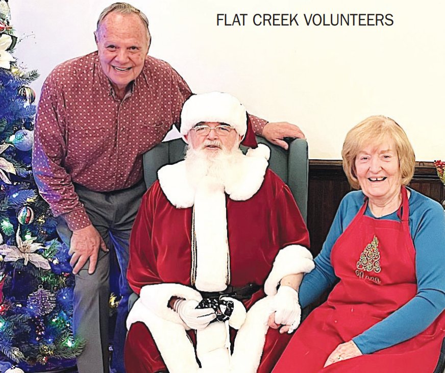 Roger and June Debatin of Flat Creek had
some fun Saturday night taking this photo with Santa
at the community center.