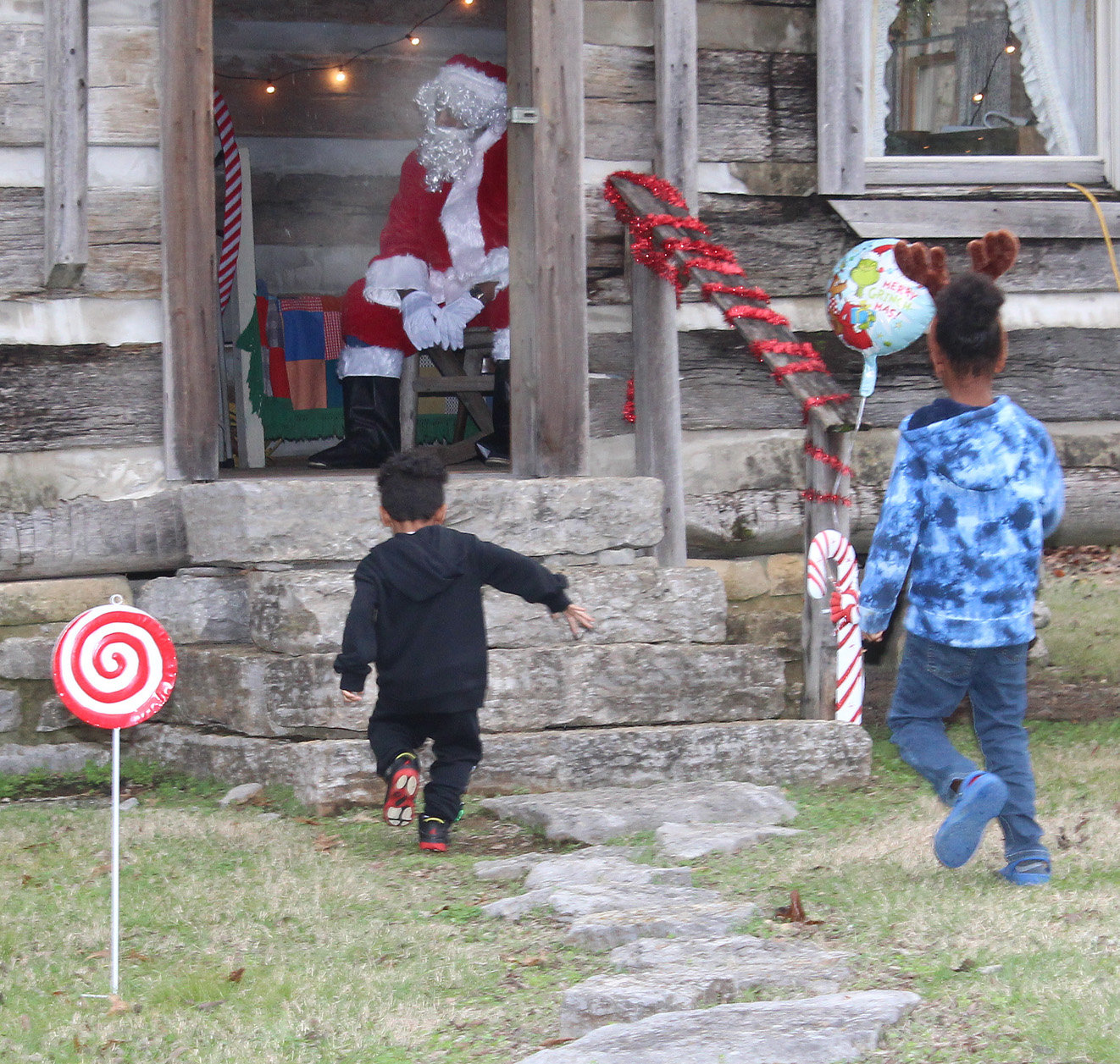 Kids ran to Santa, who was waiting inside the replica log cabin behind the main house.