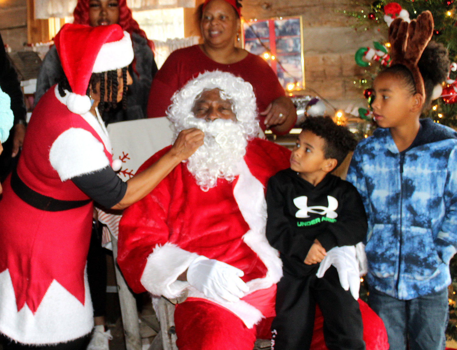 Santa’s mustache has to be just perfect, with a little help from Rosie Biggs. Santa wanted to thank Anthony Booker for getting him to the event.