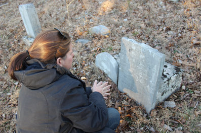 At right, Smith-Sanders, who said, “I love history,” looks closely at an inscription on a tombstone.