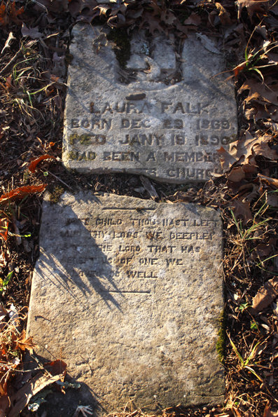 A crack on the tombstone obscures the name of the church where Laura Falk, who died at age 20 in 1890, attended - but it was likely the nearby Cross Roads Church of Christ. The cemetery is on the grounds of the former church, which disbanded many years ago.