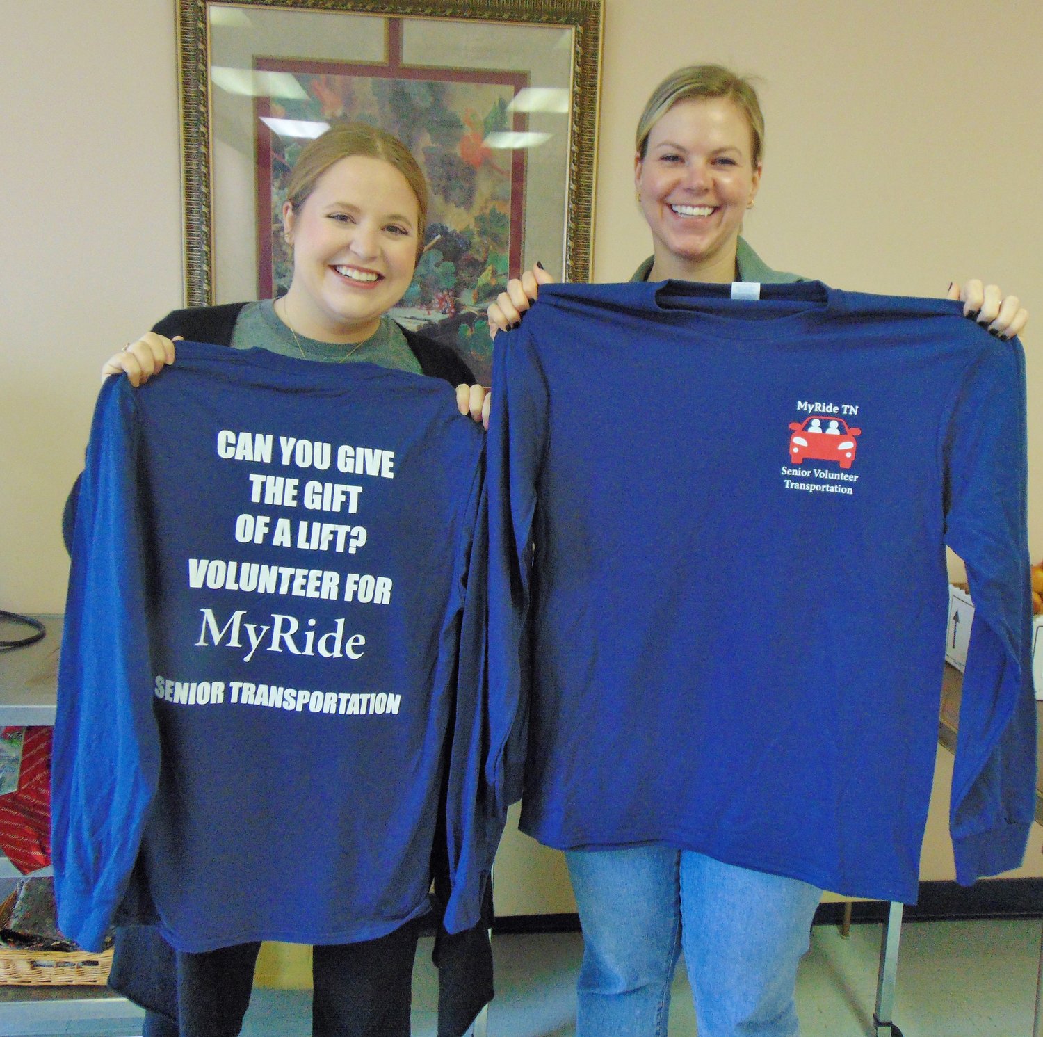 Ella Watkins and Sutherland Shrader from the First Lady Maria Lee’s office hold up MyRide TN shirts.