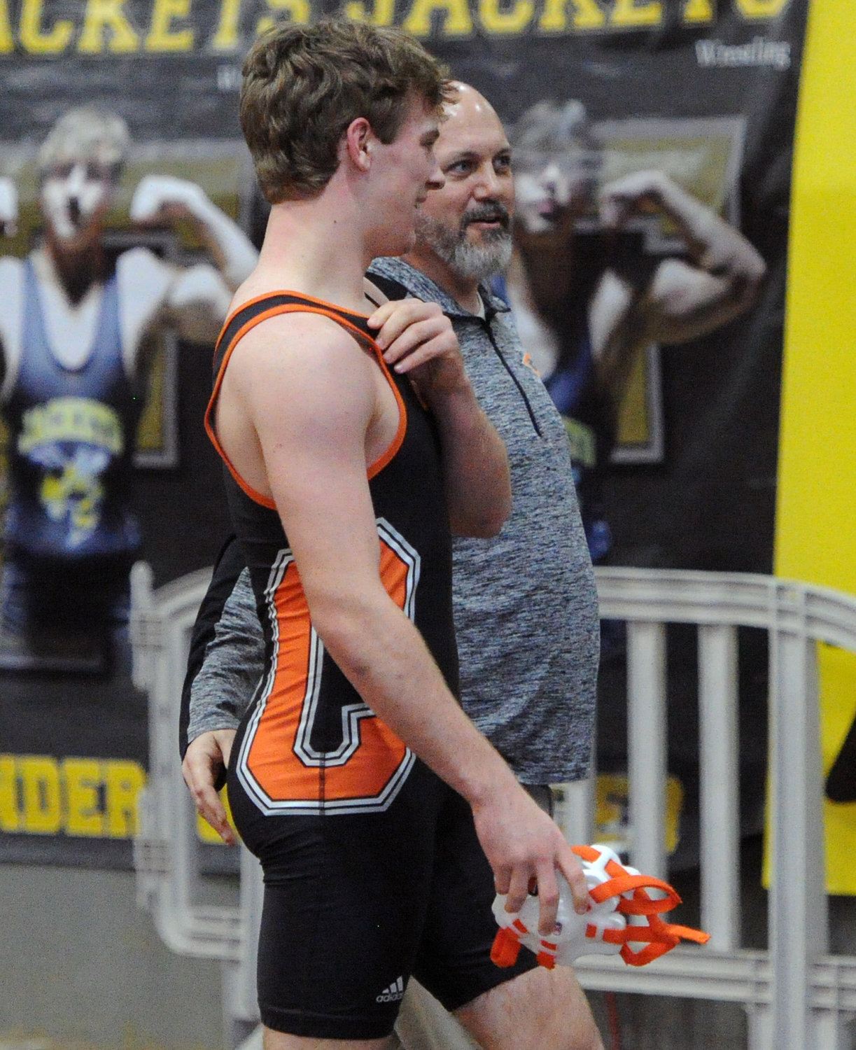 Hayden Dowell regroups with Champion coach Andy Giel after his first match in the 152-pound Class A bracket on Thursday.