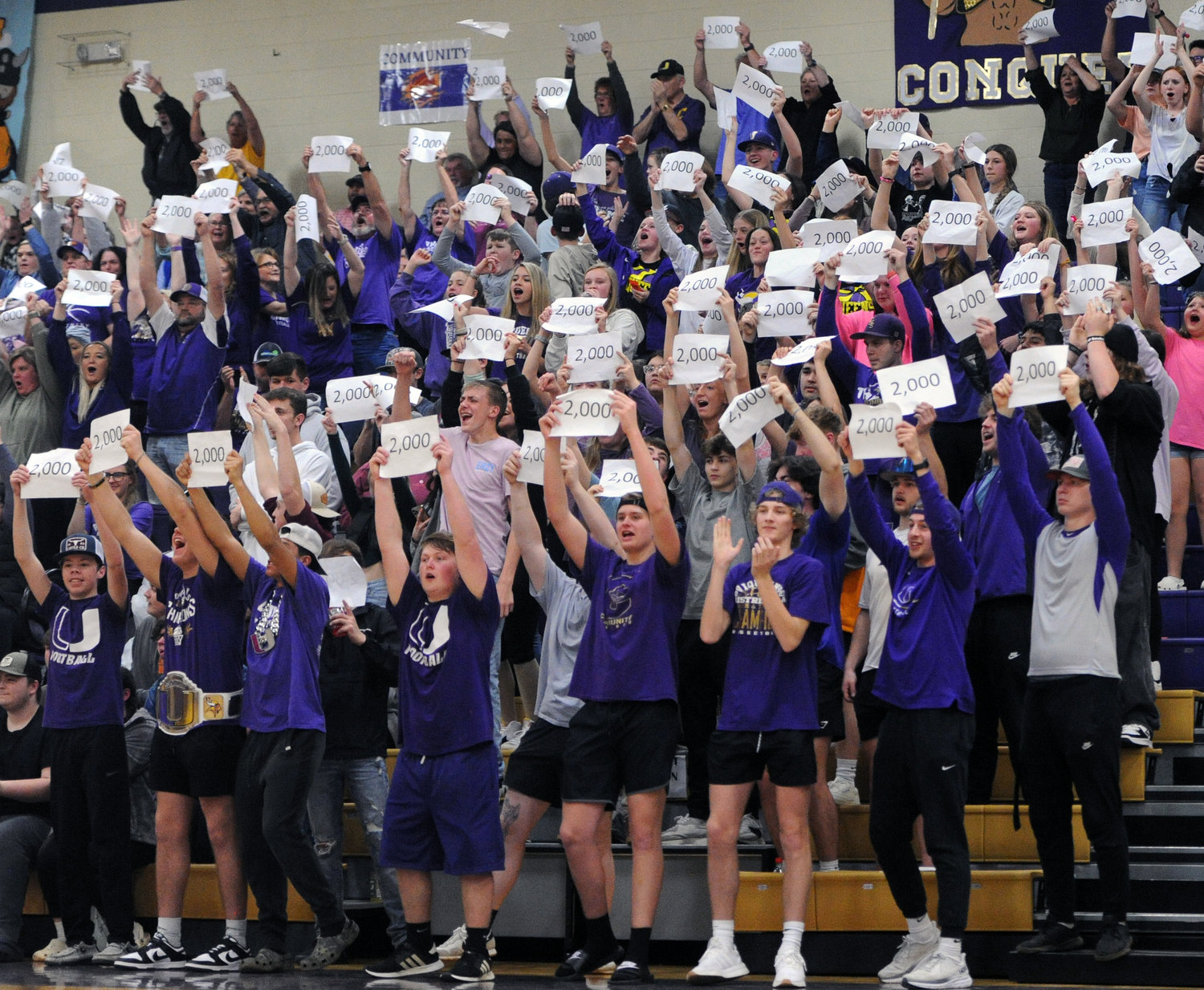 The Viqueen student section erupts and celebrates with 2,000-point signs to honor Simmons’ benchmark.