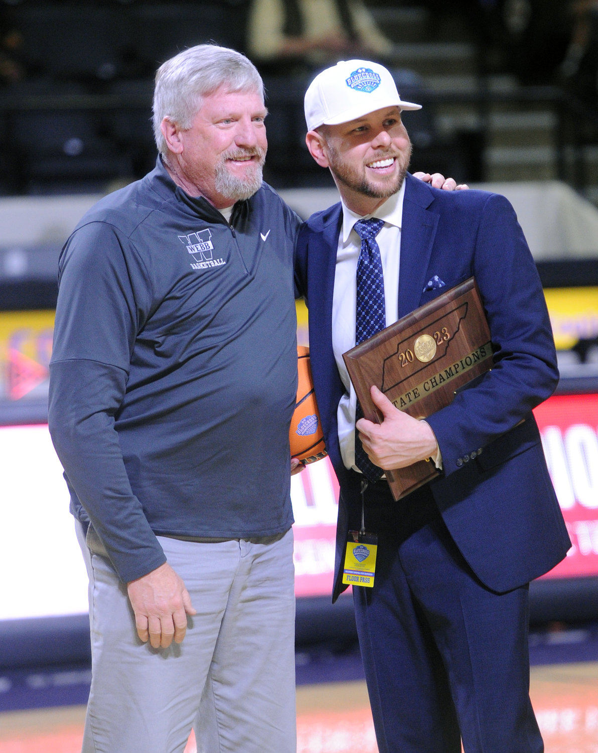 Coach Matthew Shewmake is presented with a plaque after winning the Division II Class A state championship on Saturday.