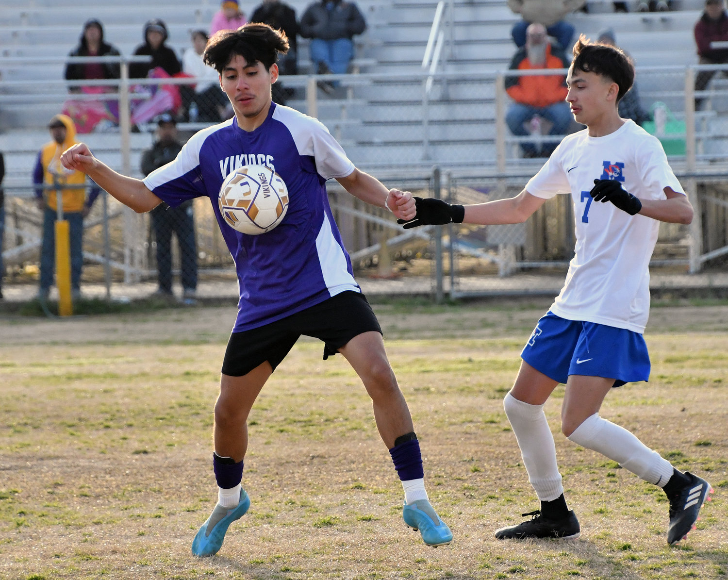 Andrew Montalvo of the Vikings and Imar Pineda (7) of the Tigers battle for the ball. 