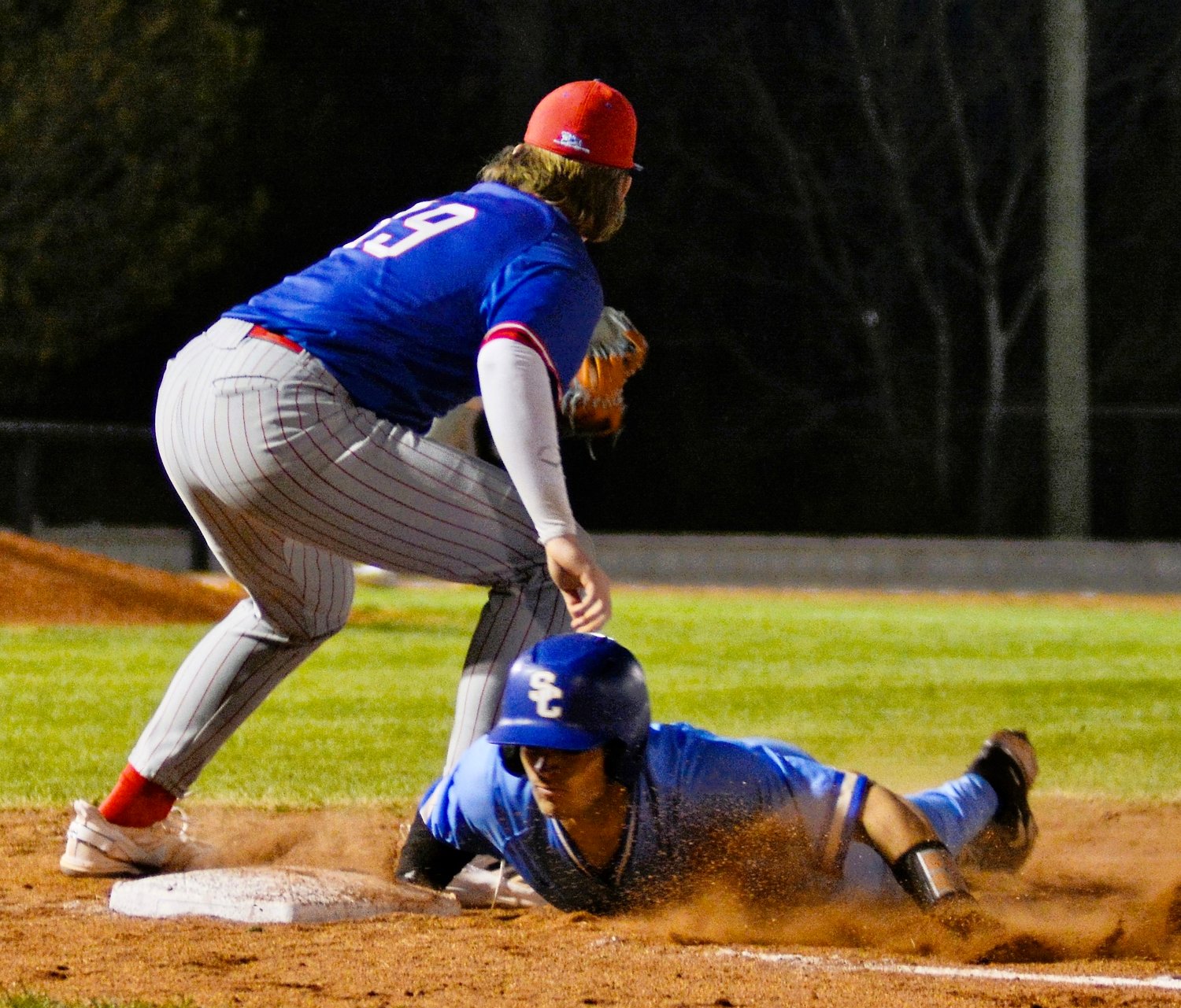 Shelbyville Central’s Nick Johnson safely dive back to first base after a pickoff attempt in the Eagles matchup against Warren County on Tuesday night.