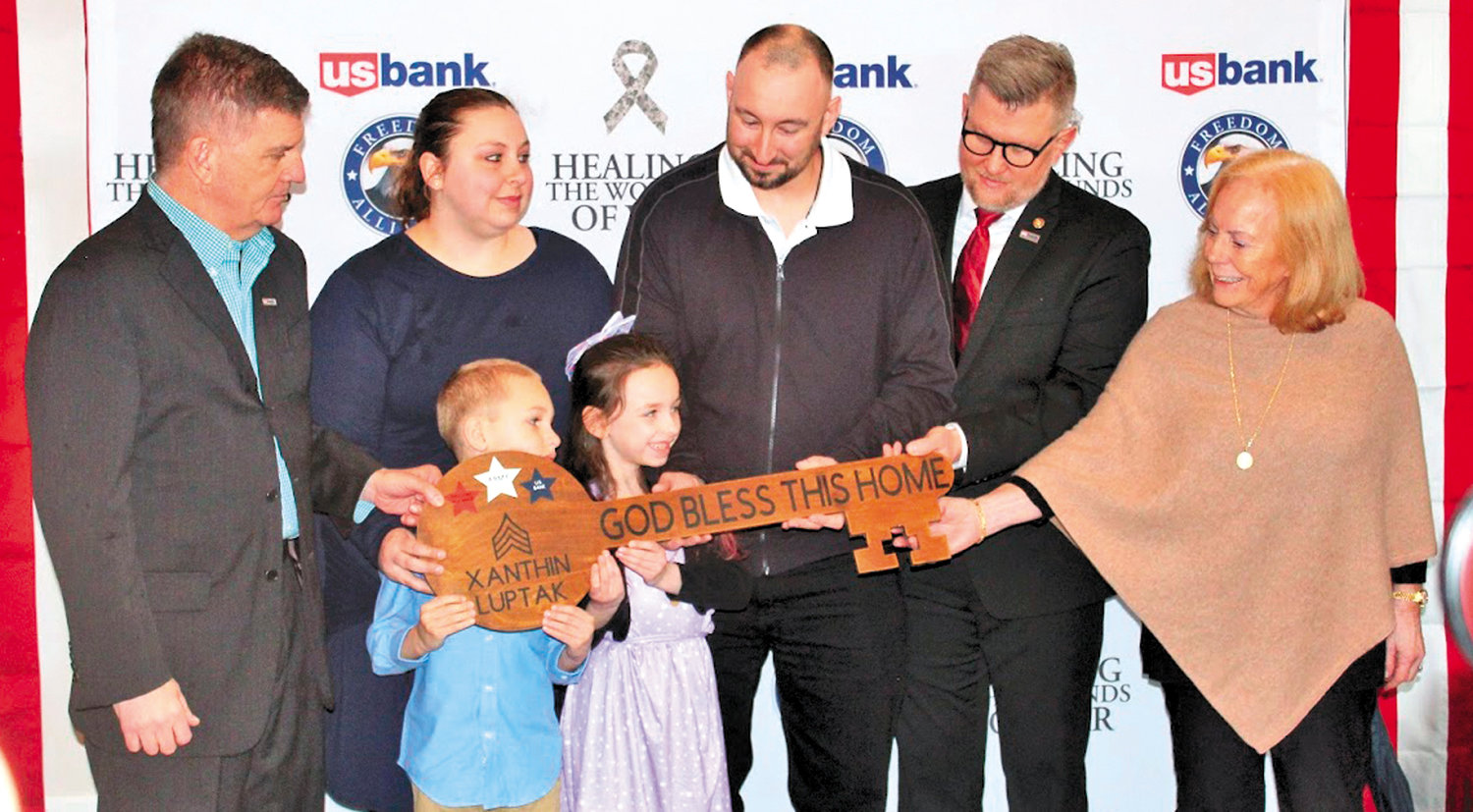 The Luptak family receives a ceremonial key to the residence.