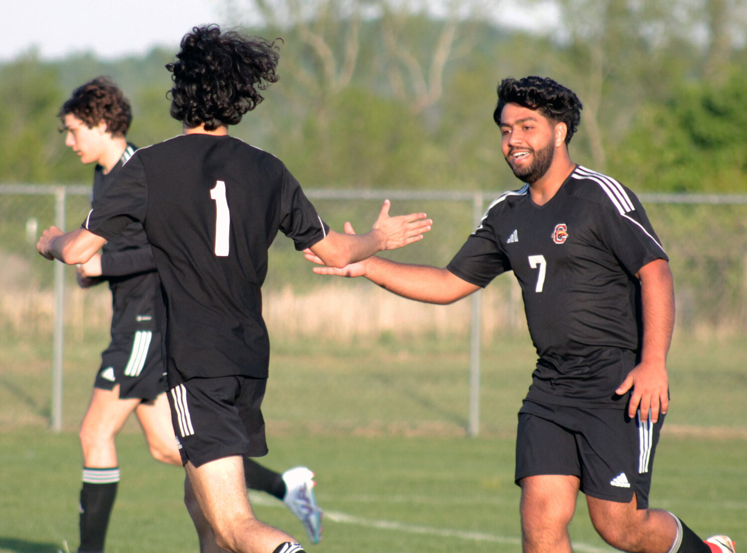 Champion forward Sam Alkhanshli celebrates with fellow senior Cooper Wood after scoring early in the second half against Warren County on Monday night. 
