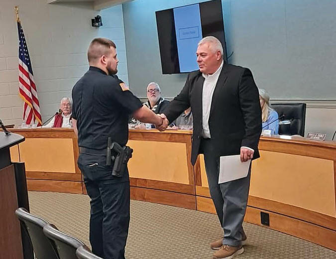 Mayor Jerry Lowery congratulates Devin Moore, the newest member of Sparta Police Department, after Moore was officially sworn in at the Feb. 1, 2024, meeting of Sparta Board of Mayor and Aldermen.