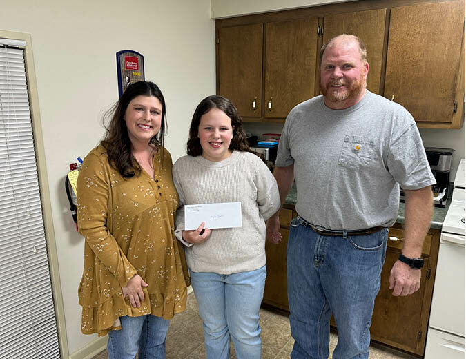 Millie Qualls, first-place winner of the White County &ldquo;Why Agriculture Is IImportant&rdquo; Farm Bureau Essay Contest, is pictured with Farm Bureau Women&rsquo;s Chairman Terra Davis (left) and White County Farm Bureau President Luke Teeple (right).