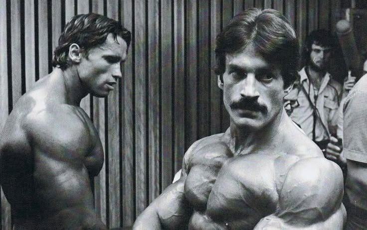 Mike Mentzer (right) and Arnold Schwarzenegger (left) at the 1980 Mr. Olympia Bodybuilding Contest, which many believe was marred by corruption.