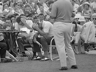 Roberto DeVincenzo with his hand over his head at the 1968 Masters after mistakenly signing par on his card instead of a birdie.  Consequently, the Argentine was forced to concede the tournament to Bob Goalby.