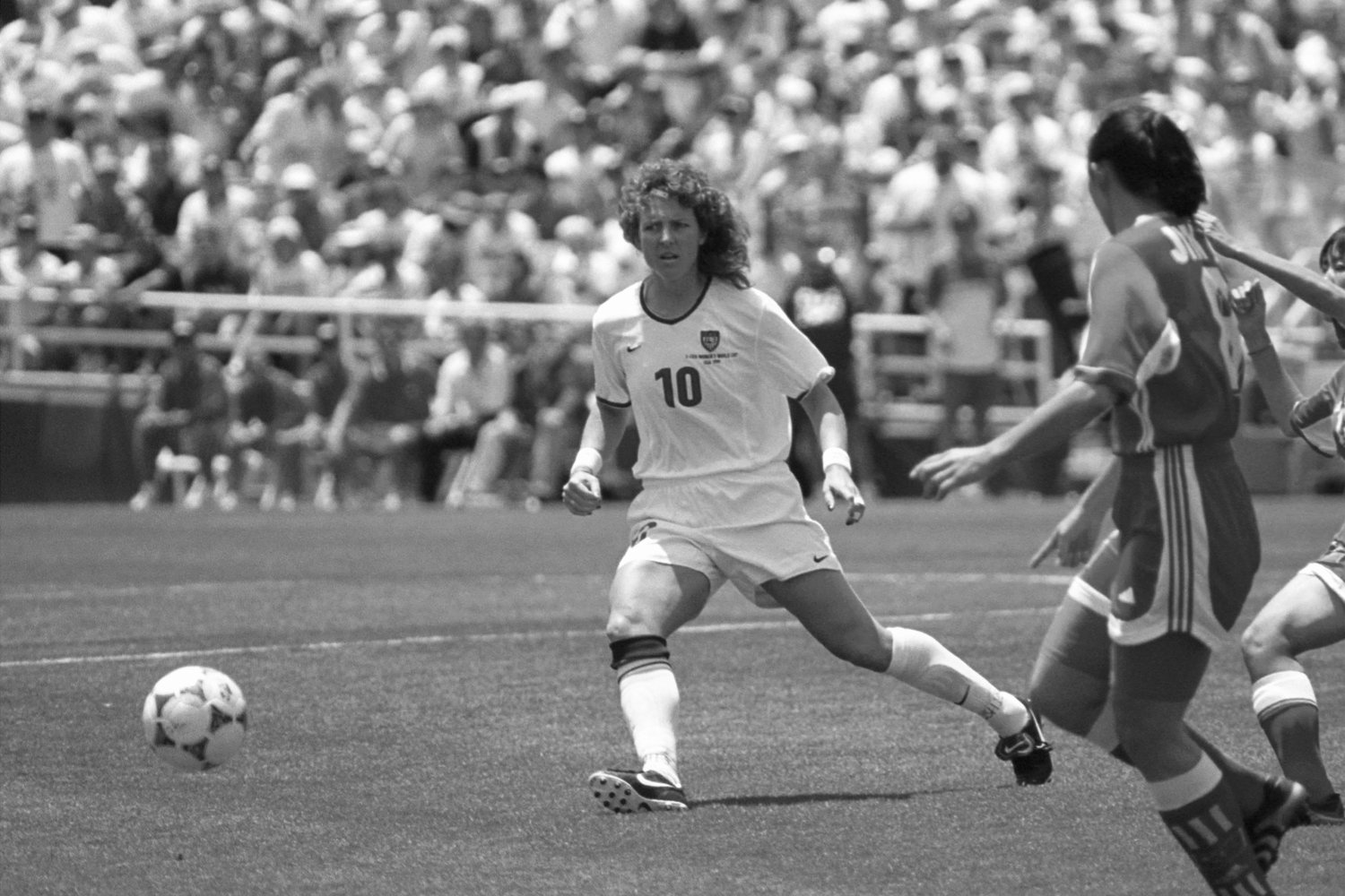 Michelle Akers in action at one of the United States Women's National Team games. As the first female global soccer star, Akers lent her unmatched heading skills and finishing touches to 2 FIFA Women's World Cup Championships (1991, 1999) and the Olympics (1996).