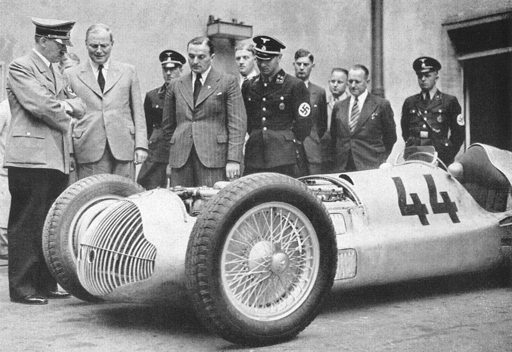 Adolf Hitler (far left) inspecting one of the 'Silver Arrows' developed by Mercedes and Auto Union. With government subsidies, the race cars were used to showcase Nazi propaganda as they dominated the Grand Prix circuits in the 1930s.