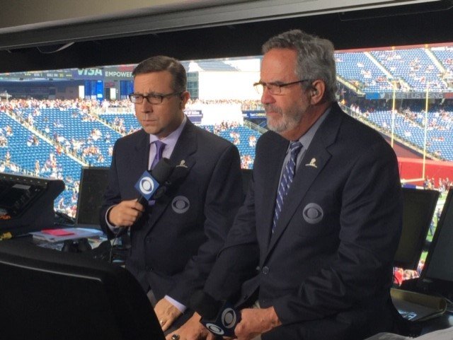 Ian Eagle (left) at the CBS broadcasting booth with Hall of Fame quarterback, Dan Fouts. Eagle has worked with dozens of renowned broadcasting partners over the course of his career, including 10 years with Fouts.