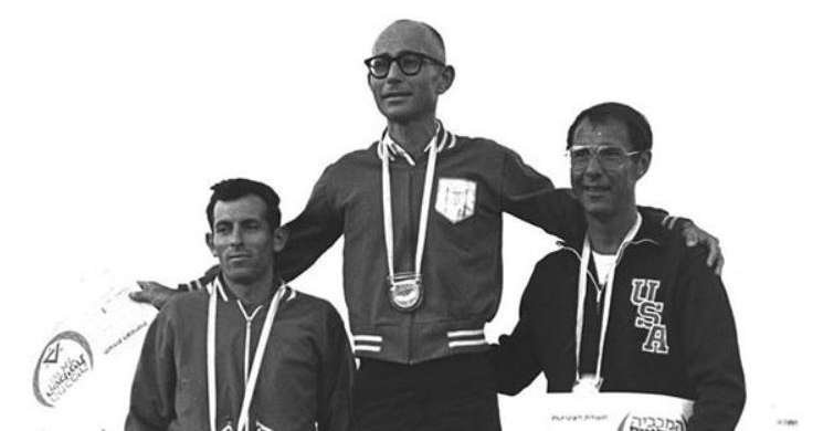 Shaul Ladany (center) receiving his gold medal at the 1969 Maccabiah Games. A survivor of the Holocaust and the Munich Massacre, Ladany was a 2-time Olympian and former world champion in the 100-km racewalking event.