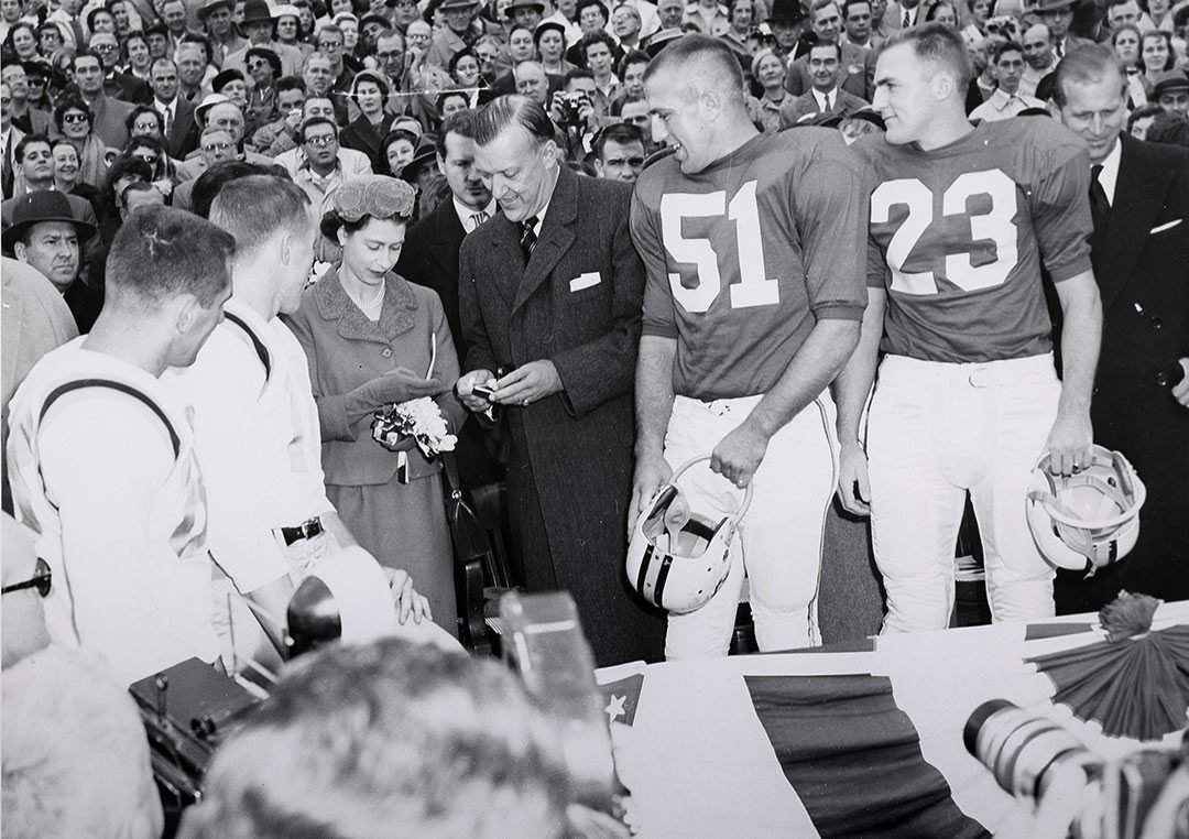 Queen Elizabeth II attending a University of Maryland football game on October 19, 1957. It was Her Majesty's first visit to the United States and an opportunity to witness a quintessential American sport.