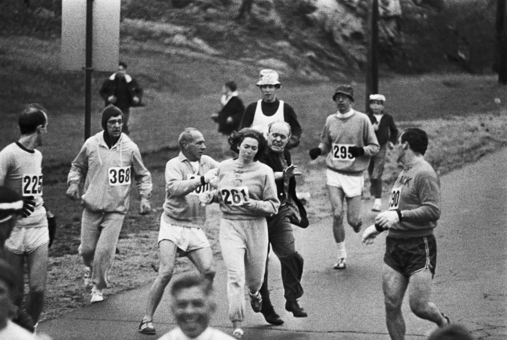 Kathrine Switzer wearing #261 attacked by a race official from behind at the 1967 Boston Marathon. The pioneer runner became the first woman to officially compete at a marathon.