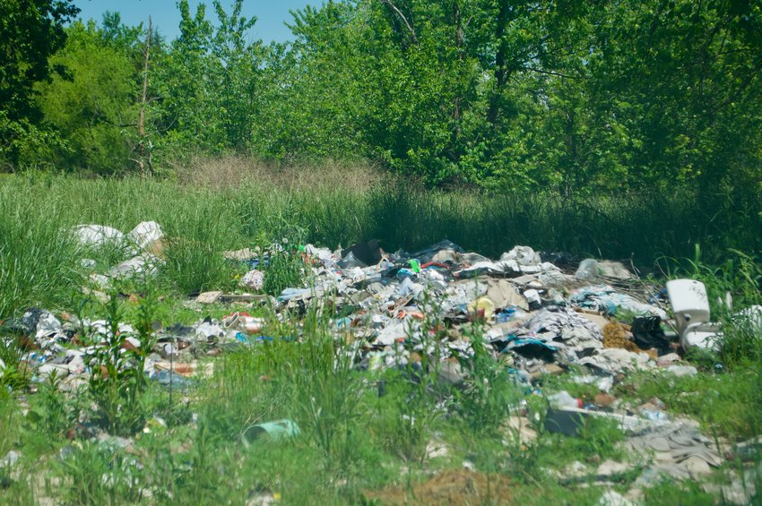 As the alleged owner of Airport Village faces a felony disposition of solid waste charge, accumulated waste can be seen in this shot at Airport Village on Mo. 39.