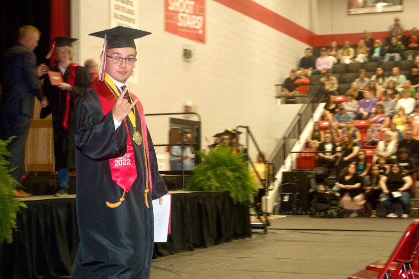 Stockton High School class of 2022 valedictorian Tyler Johnson &ldquo;hangs ten&rdquo; in excitement as he exits the stage with his diploma on Sunday, May 22.