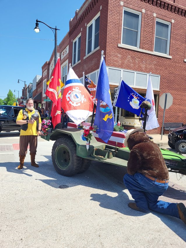 Jonathan Taylor&rsquo;s trailer honoring all branches of service was on display at Hughes Brothers Theater in Branson during the Fourth of July activities and has been on display in various communities throughout the area. Above, Smokey the Bear kneels in front of the flags.