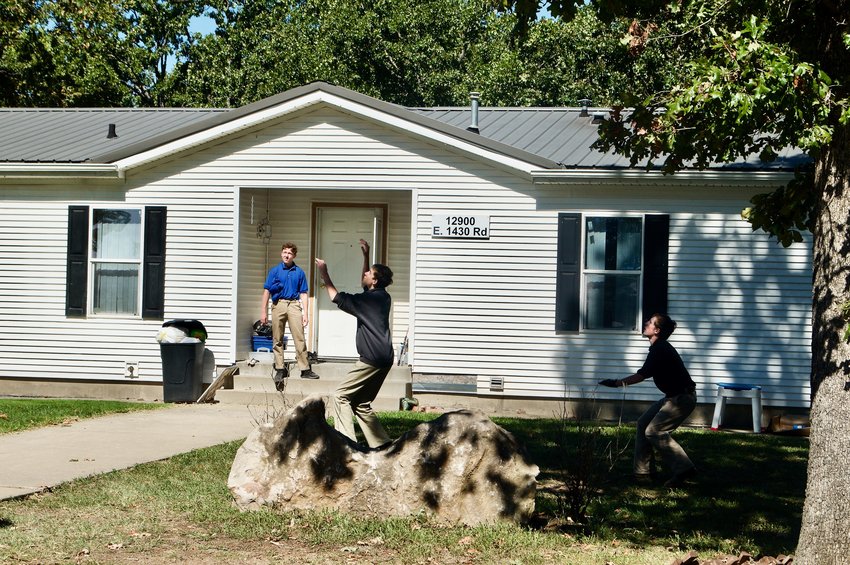 Agape students play football outside one of the five group homes on the property.