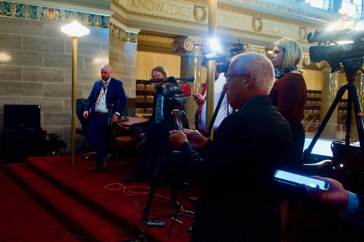 Manring livestreams, front, Rep. Sarah Unsicker's press conference in the Capitol last week.