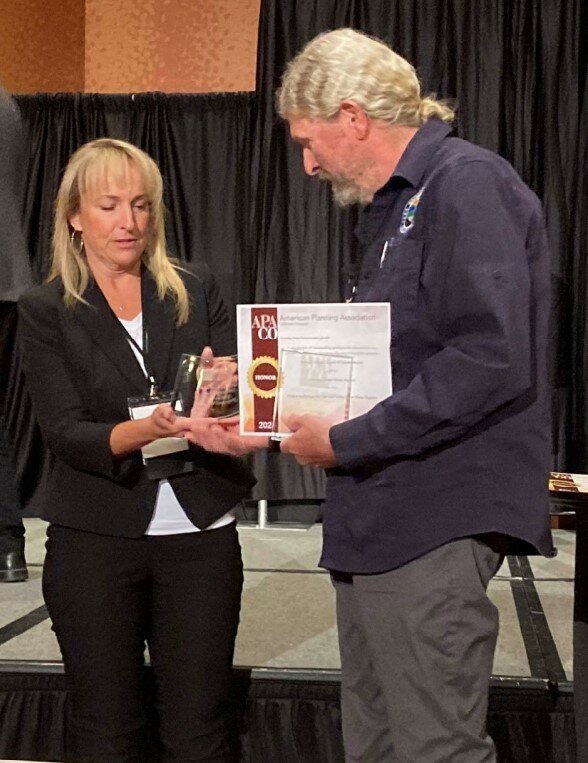 Saguache County Commissioner Tom McCracken accepting the 2024 American Planning Award Colorado Honor Award. 