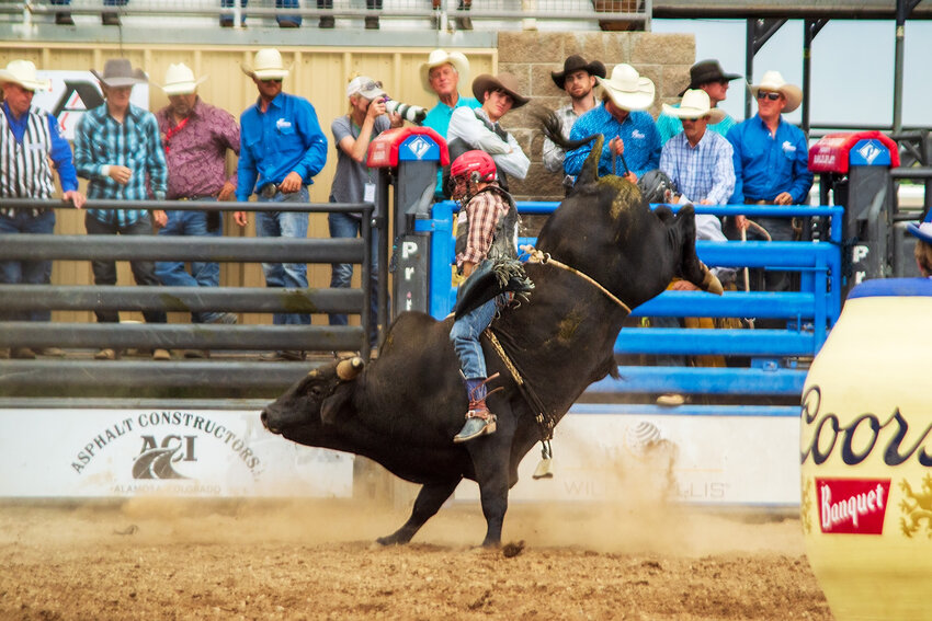 Scottie Knapp of Albuquerque, N.M., rides Ironman for an 86 1/2 point ride to win bull riding on Sunday.