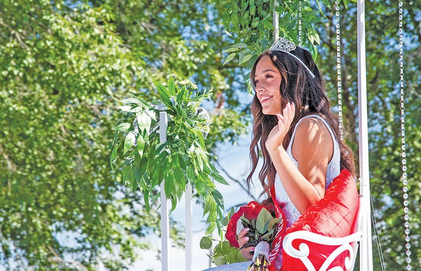 Miss Pioneer Deja Valdez waves to the crowd during the Manassa Pioneer Days Parade on Friday.
