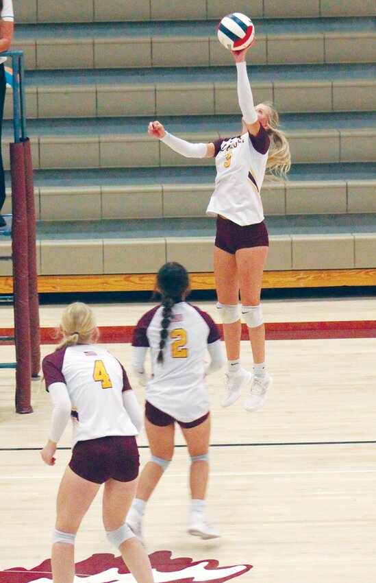 Alamosa High School’s Taybor Wiedeman (3) hits the ball in Saturday’s match against Hoehne at the AHS gym while Lily Heersink (4) and Kadie Hawkins (12) stand by. The Lady Mean Moose defeated both Hoehne and Gunnison, both in three sets.