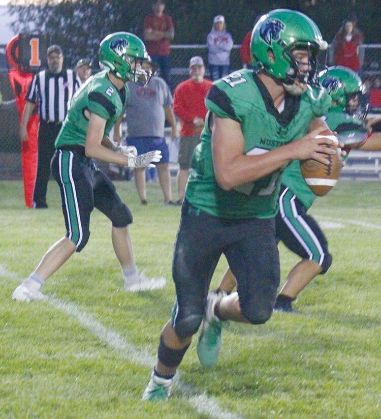 Sanford High School’s Trason Gartrell (21) rolls out for a pass in last Friday’s game against Haxtun. The Mustangs host Fowler this coming Friday with kickoff scheduled for 7 p.m.